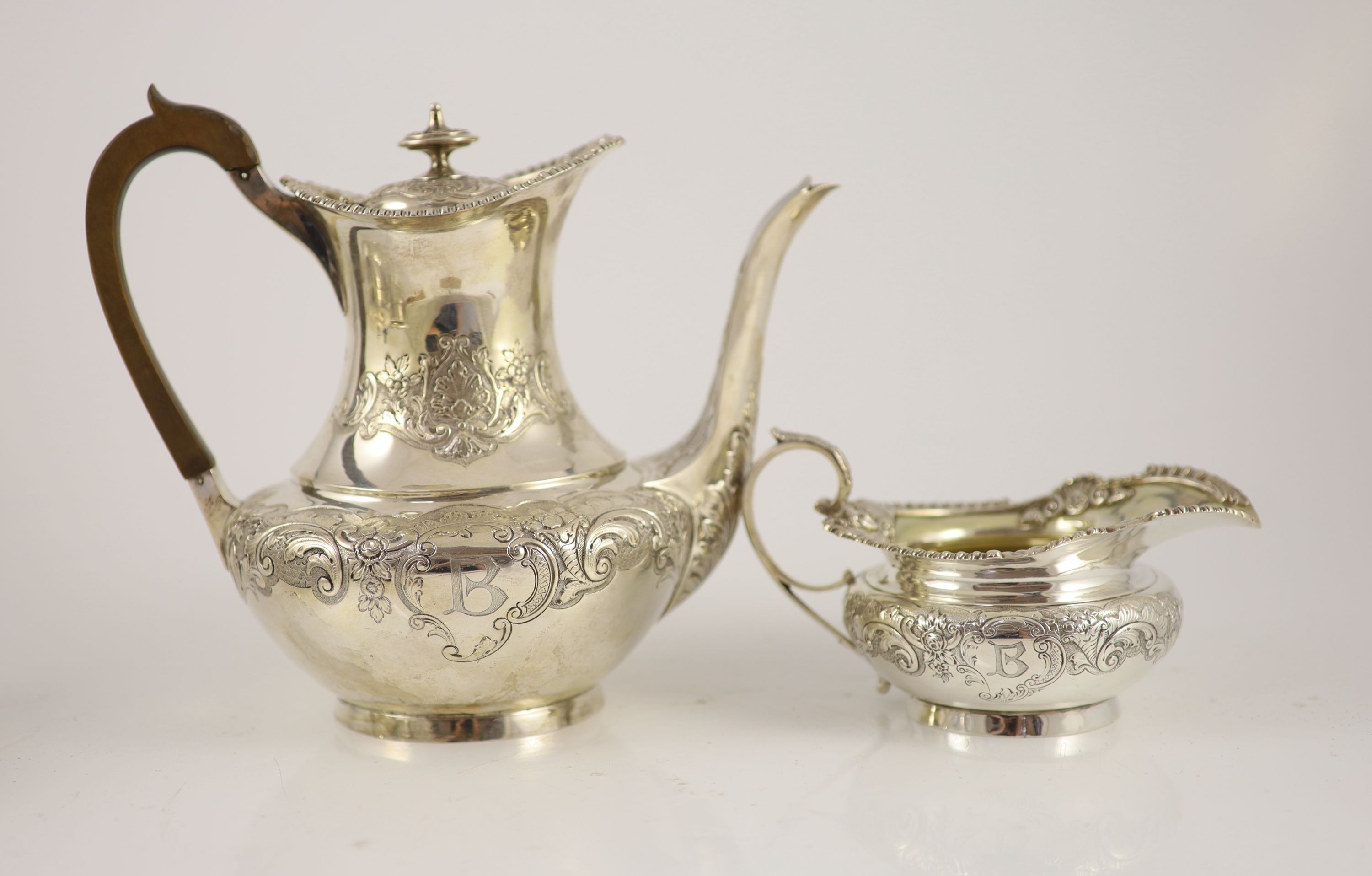 An Edwardian embossed silver circular four piece tea and coffee service by Edward Barnard & Sons Ltd